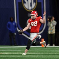 Dec 7, 2024; Atlanta, GA, USA; Georgia Bulldogs punter Brett Thorson (92) punts the ball to the Texas Longhorns during the first half in the 2024 SEC Championship game at Mercedes-Benz Stadium.