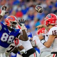 Georgia Bulldogs quarterback Carson Beck (15) is pressured by Florida Gators defensive lineman Caleb Banks (88) during the third quarter of an NCAA football game Saturday, Oct. 28, 2023 at EverBank Stadium in Jacksonville, Fla. Georgia defeated Florida 43-20.