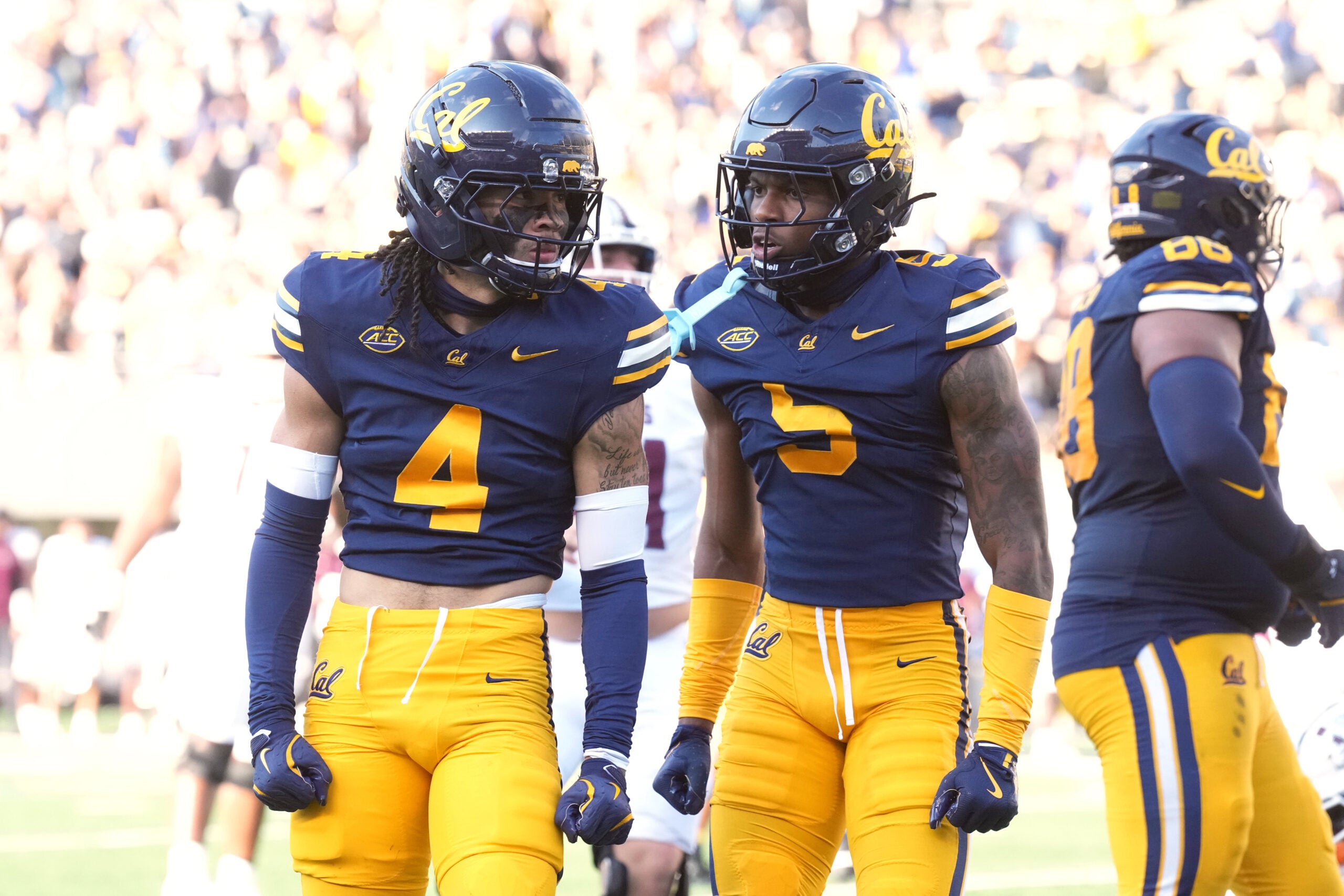 Sep 6, 2025; Berkeley, California, USA; California Golden Bears defensive backs Brent Austin (4) and Hezekiah Masses (5) react after a defensive play during the fourth quarter against the Texas Southern Tigers at California Memorial Stadium.