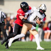 Oct 11, 2025; Cincinnati, Ohio, USA; Cincinnati Bearcats linebacker Jake Golday (11) attempts to tackle UCF Knights quarterback Cam Fancher (14) in the second half at Nippert Stadium.