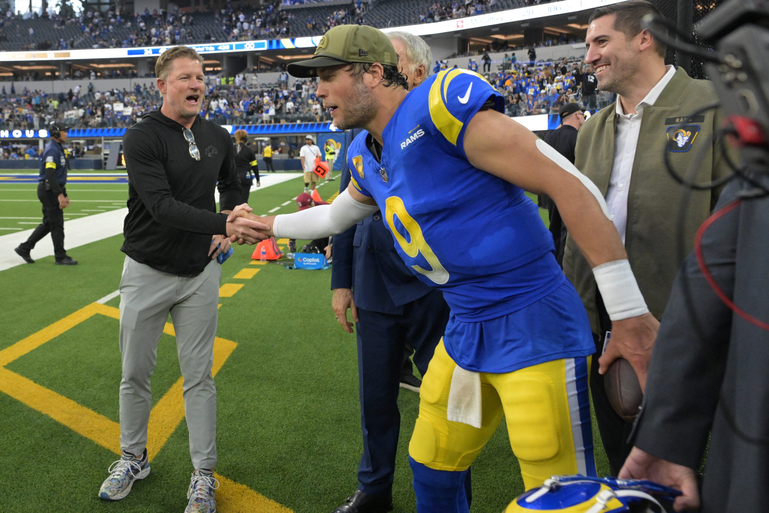 Les Snead, general manager of the Los Angeles Rams shakes the hand of quarterback Matthew Stafford (9) following a game against the New Orleans Saints at SoFi Stadium.