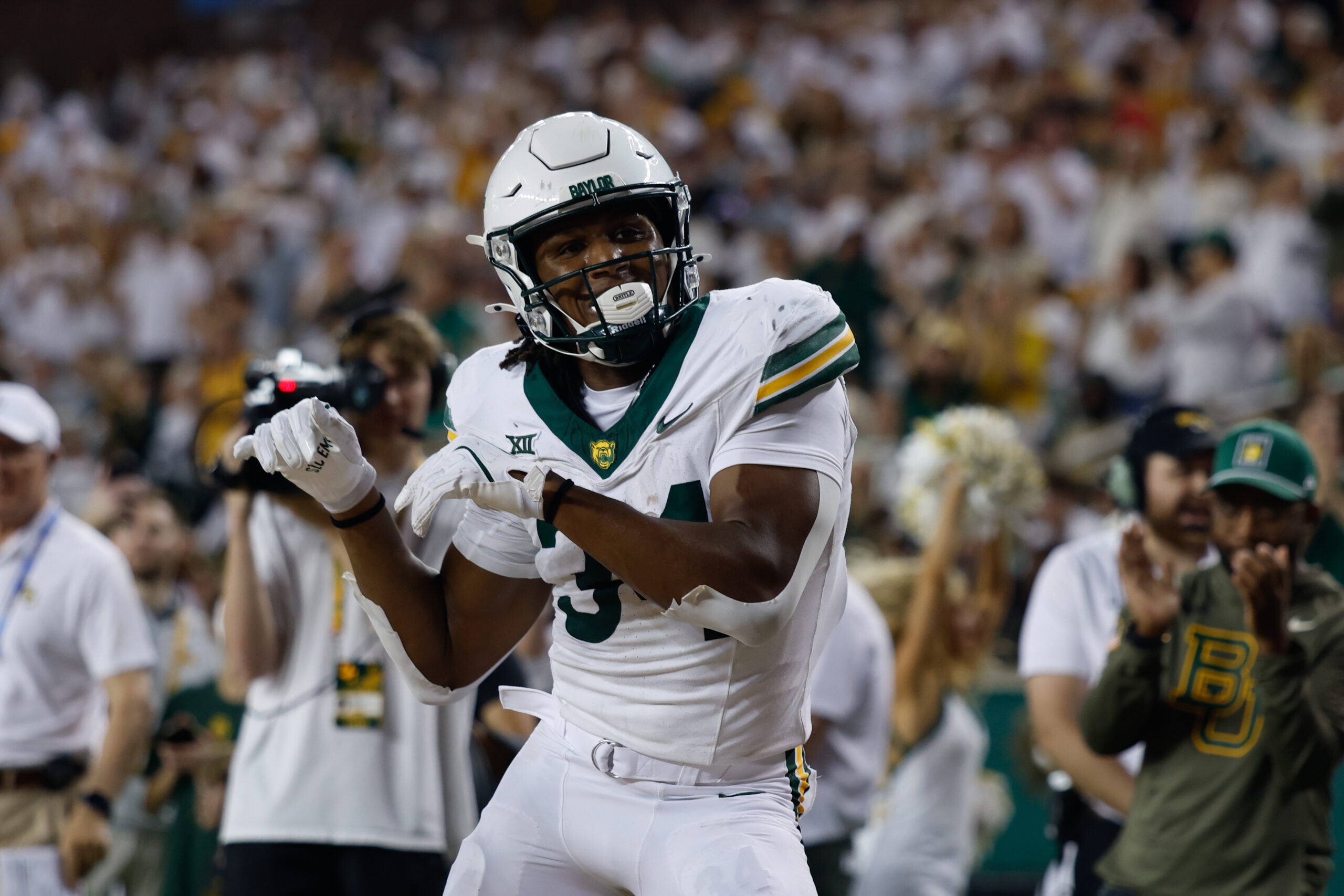 Nov 15, 2025; Waco, Texas, USA; Baylor Bears wide receiver Josh Cameron (34) reacts after scoring a touchdown against the Utah Utes during the first half at McLane Stadium.