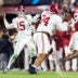 Dec 19, 2025; Norman, OK, USA; Alabama Crimson Tide quarterback Ty Simpson (15) and offensive lineman Kadyn Proctor (74) against the Oklahoma Sooners during the CFP National Playoff First Round at Gaylord Family Oklahoma Memorial Stadium.
