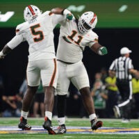 Dec 31, 2025; Arlington, TX, USA; Miami Hurricanes defensive lineman Justin Scott (5) and defensive lineman David Blay, Jr. (11) celebrates in the second quarter during the 2025 Cotton Bowl and quarterfinal game of the College Football Playoff at AT&T Stadium.