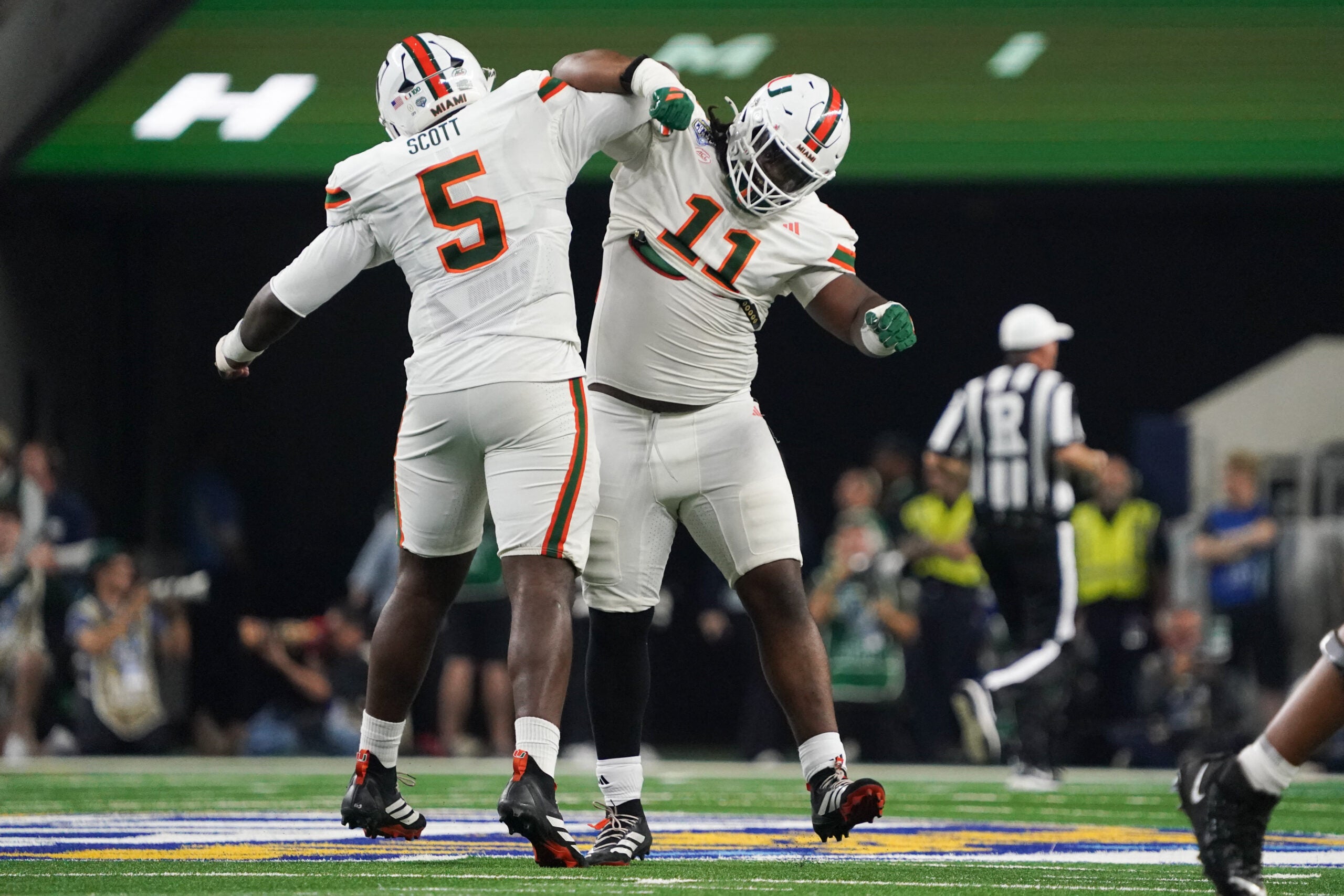 Dec 31, 2025; Arlington, TX, USA; Miami Hurricanes defensive lineman Justin Scott (5) and defensive lineman David Blay, Jr. (11) celebrates in the second quarter during the 2025 Cotton Bowl and quarterfinal game of the College Football Playoff at AT&T Stadium.