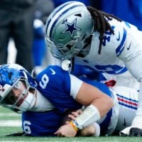 New York Giants quarterback Jaxson Dart (6) is tackled by Dallas Cowboys defensive end Jadeveon Clowney (42), Sunday, January 4, 2026, in East Rutherford.
