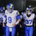Jan 18, 2026; Chicago, IL, USA; Los Angeles Rams quarterback Matthew Stafford (9), guard Kevin Dotson (69), safety Quentin Lake (37) and offensive tackle David Quessenberry (68) run onto the field before an NFC Divisional Round game against the Chicago Bears at Soldier Field.