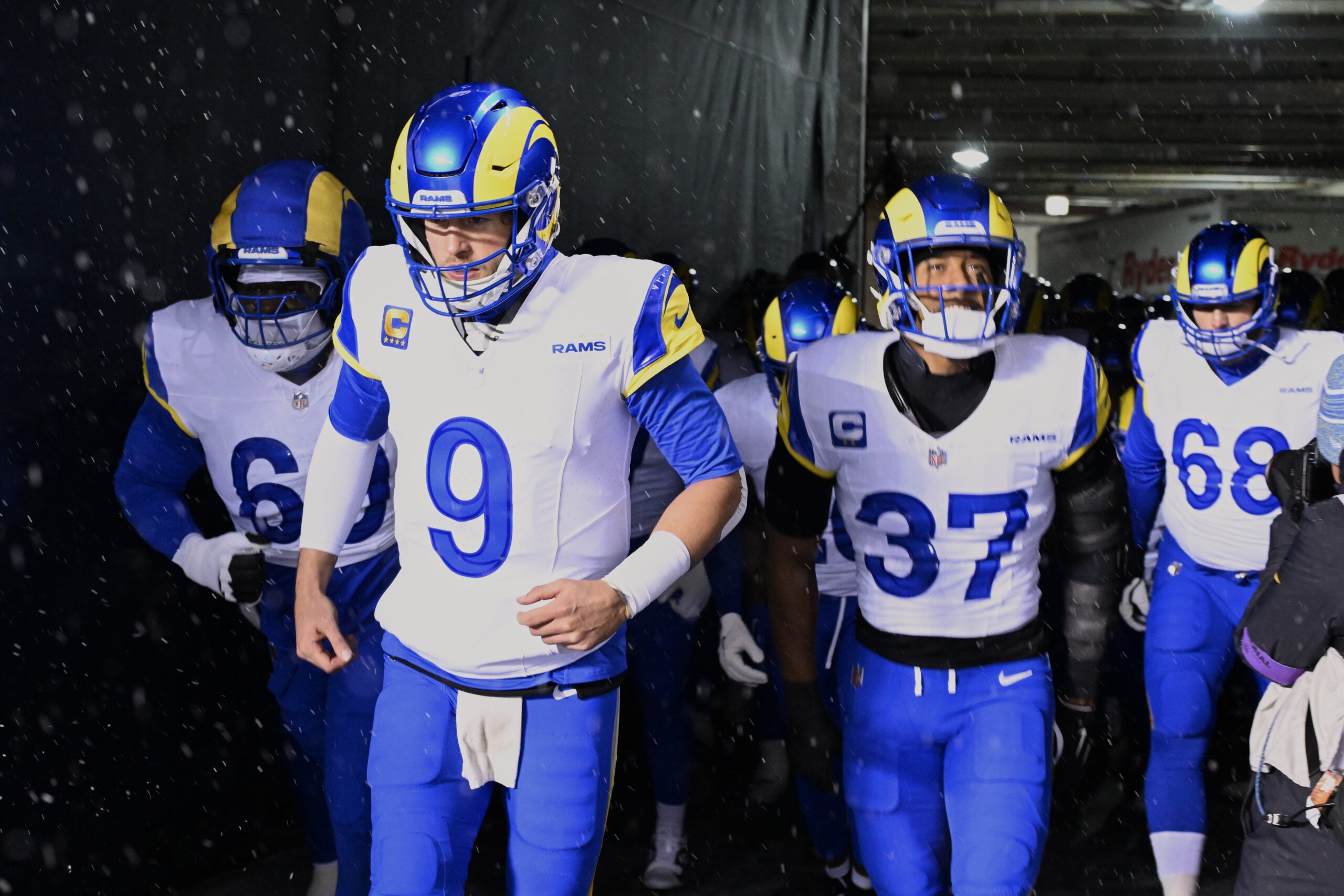 Jan 18, 2026; Chicago, IL, USA; Los Angeles Rams quarterback Matthew Stafford (9), guard Kevin Dotson (69), safety Quentin Lake (37) and offensive tackle David Quessenberry (68) run onto the field before an NFC Divisional Round game against the Chicago Bears at Soldier Field.