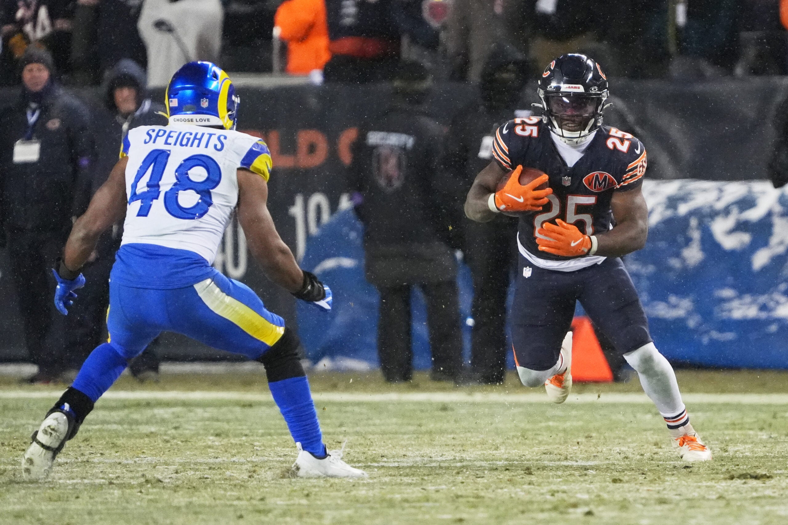 Jan 18, 2026; Chicago, IL, USA; Chicago Bears running back Kyle Monangai (25) runs the ball against Los Angeles Rams linebacker Omar Speights (48) during overtime of an NFC Divisional Round game at Soldier Field.