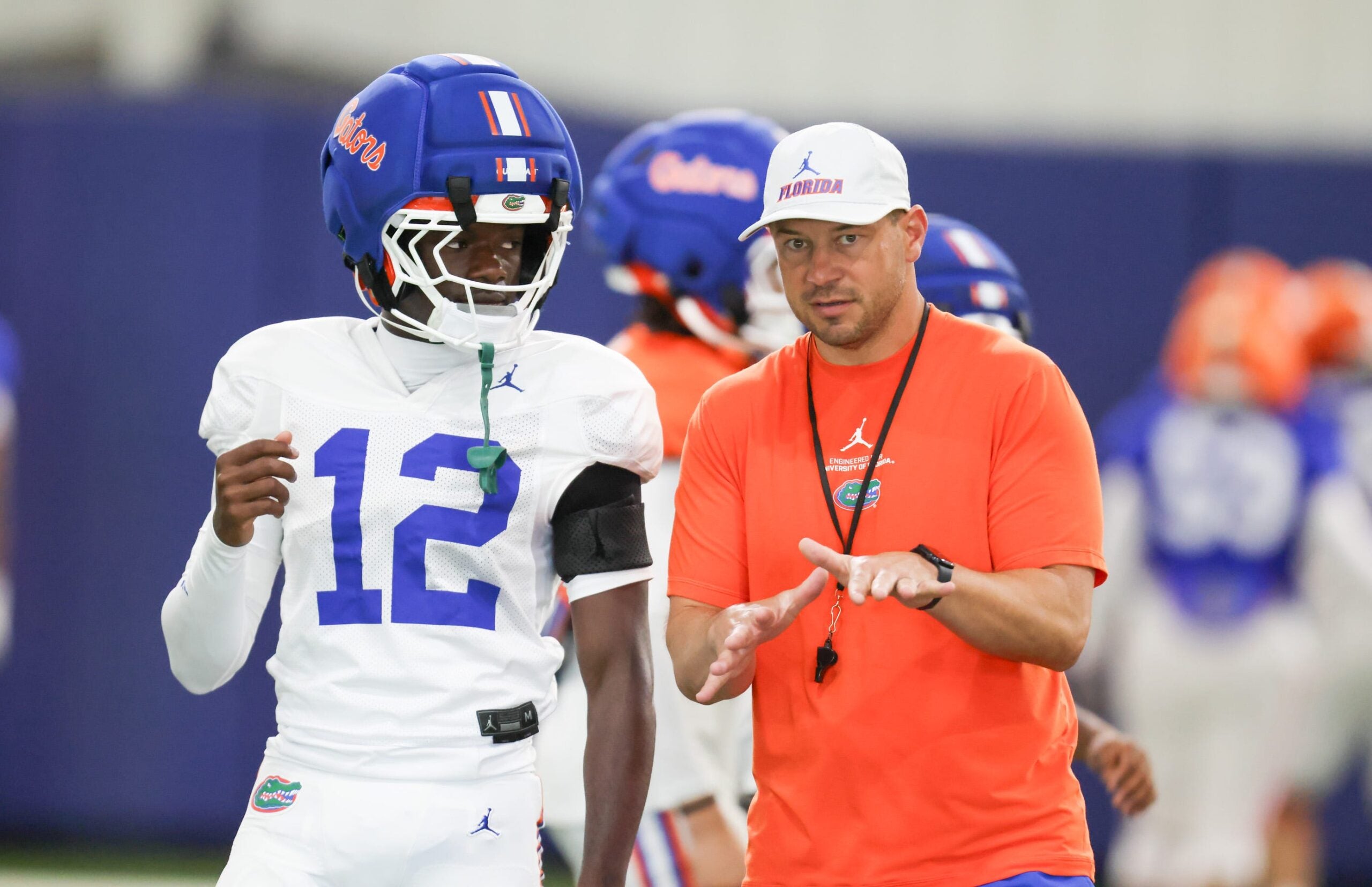 Florida head coach Jon Sumrall talks with Florida cornerback Ben Hanks II (12) during practice during spring practice at Sanders Practice Fields in Gainesville, FL on Thursday, April 2, 2026.