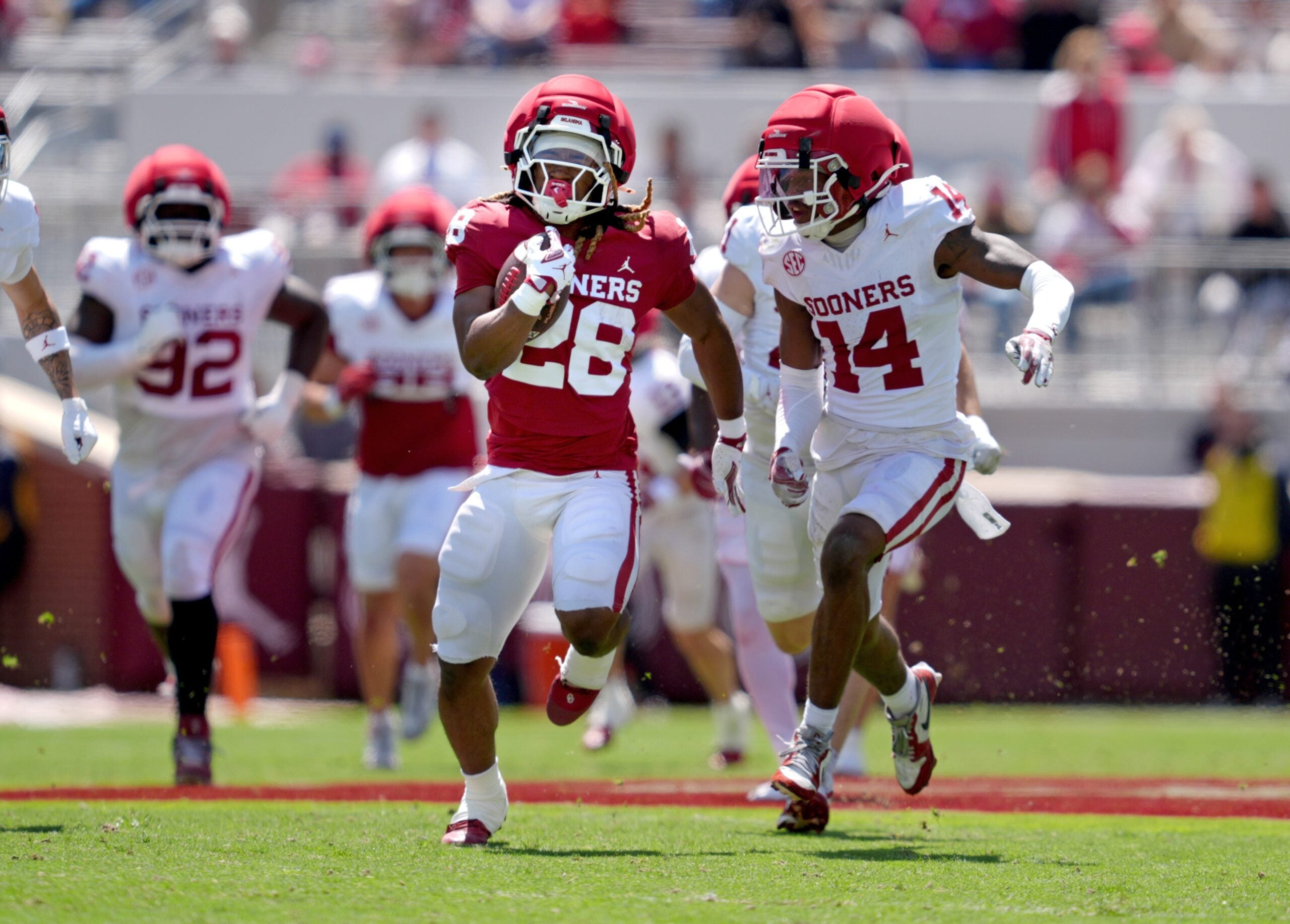 Oklahoma's DeZephen Walker (28) rushes as Trystan Haynes (14) chases him during the University of Oklahoma Sooners Spring Game at the Gaylord Family - Oklahoma Memorial Stadium in Norman, Okla., Saturday April 18, 2026.