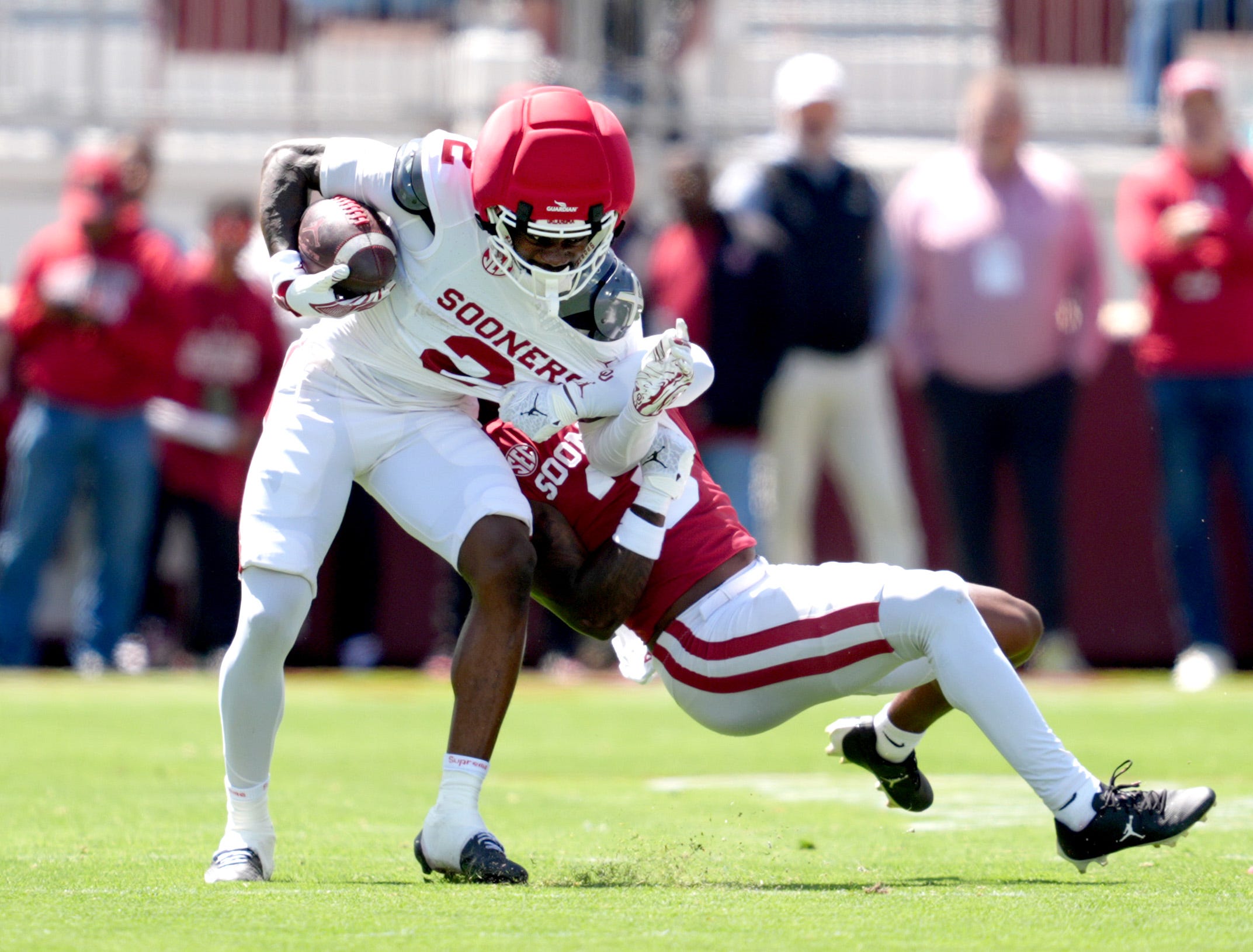 Oklahoma's Jahsiear Rogers (2) makes a catch as Reggie Powers III (3) tackles him during the University of Oklahoma Sooners Spring Game at the Gaylord Family - Oklahoma Memorial Stadium in Norman, Okla., Saturday April 18, 2026.