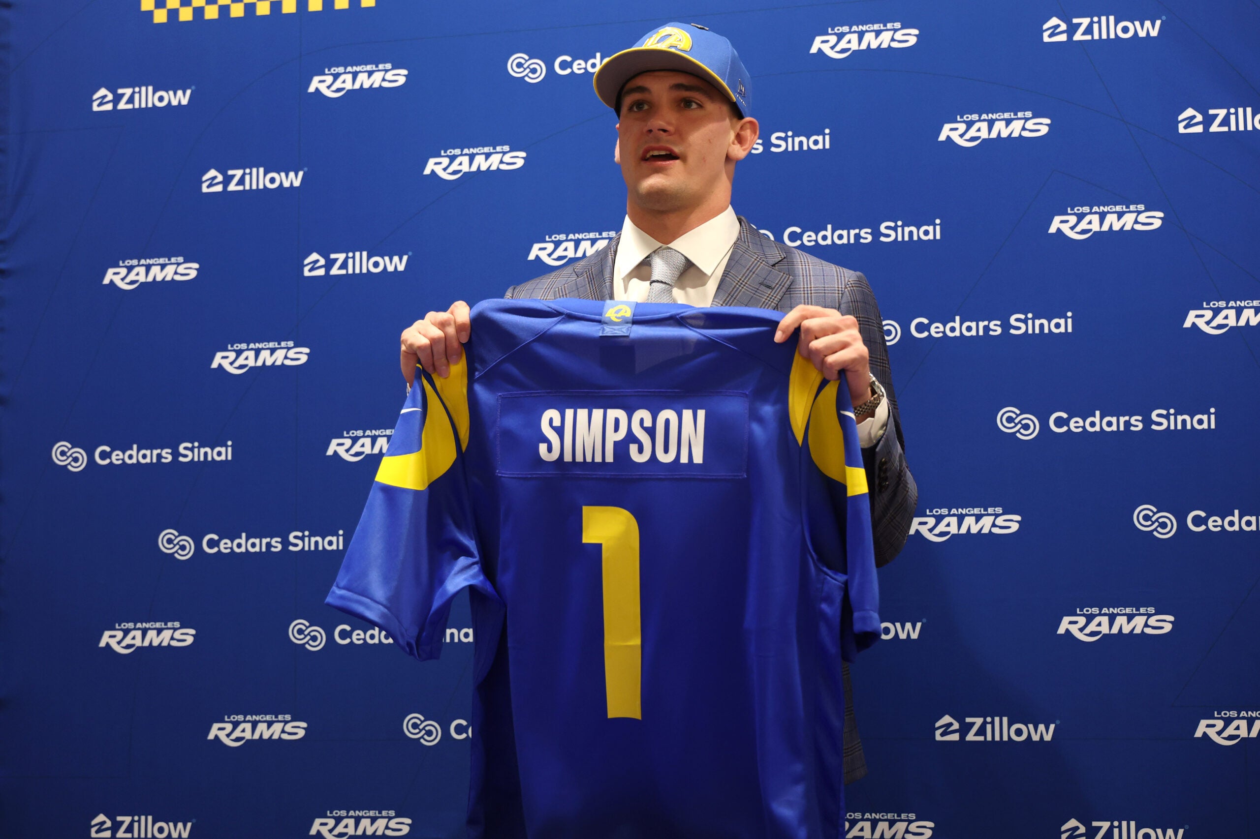 Apr 24, 2026; Inglewood, CA, USA; Los Angeles Rams first-round draft pick Ty Simpson poses with his jersey during a press conference at Code Next at Hollywood Park.