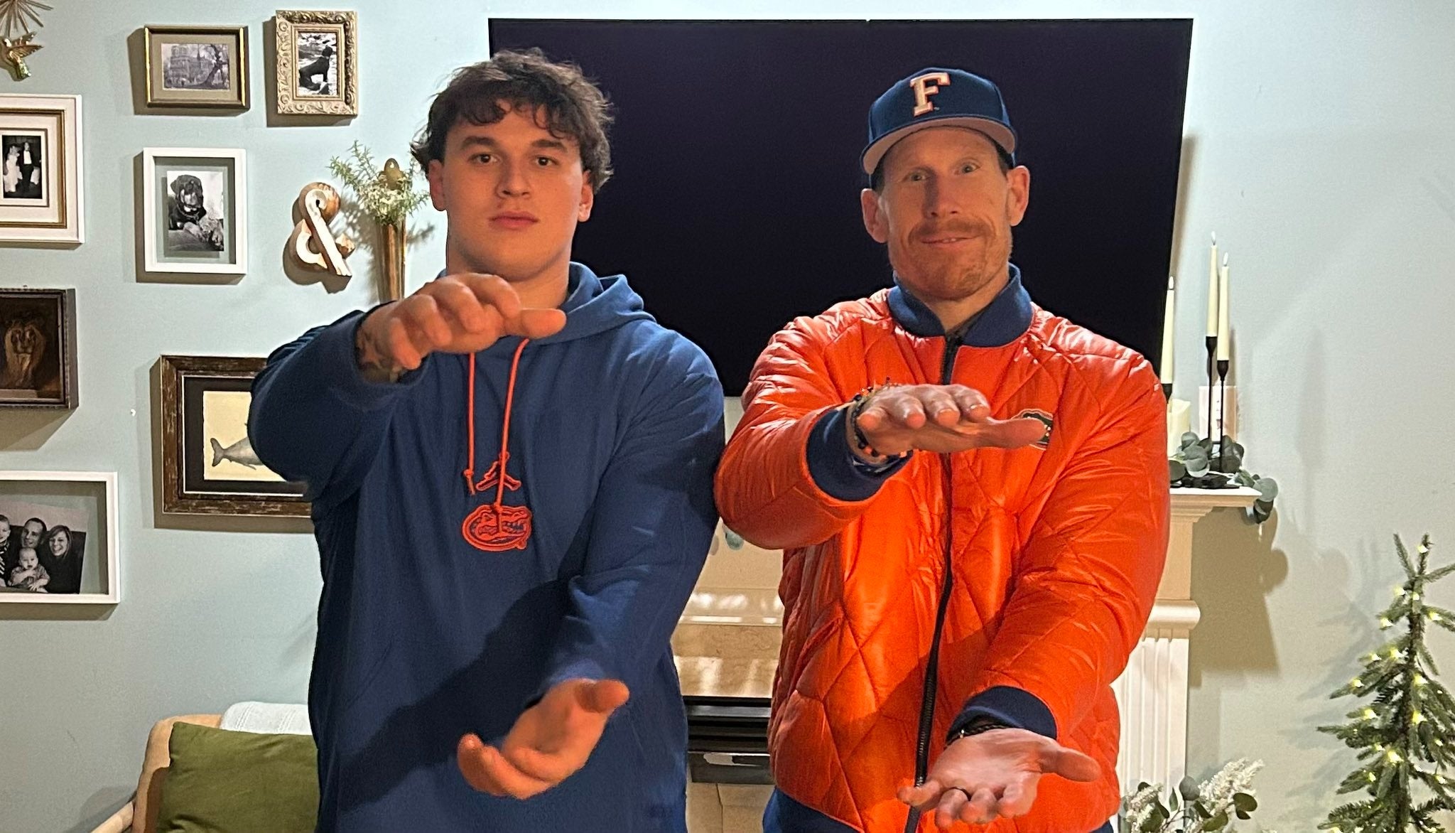 Florida Gators offensive line coach Phil Trautwein does the Gator chomp while visiting 2027 five-star offensive line recruit Maxwell Hiller.