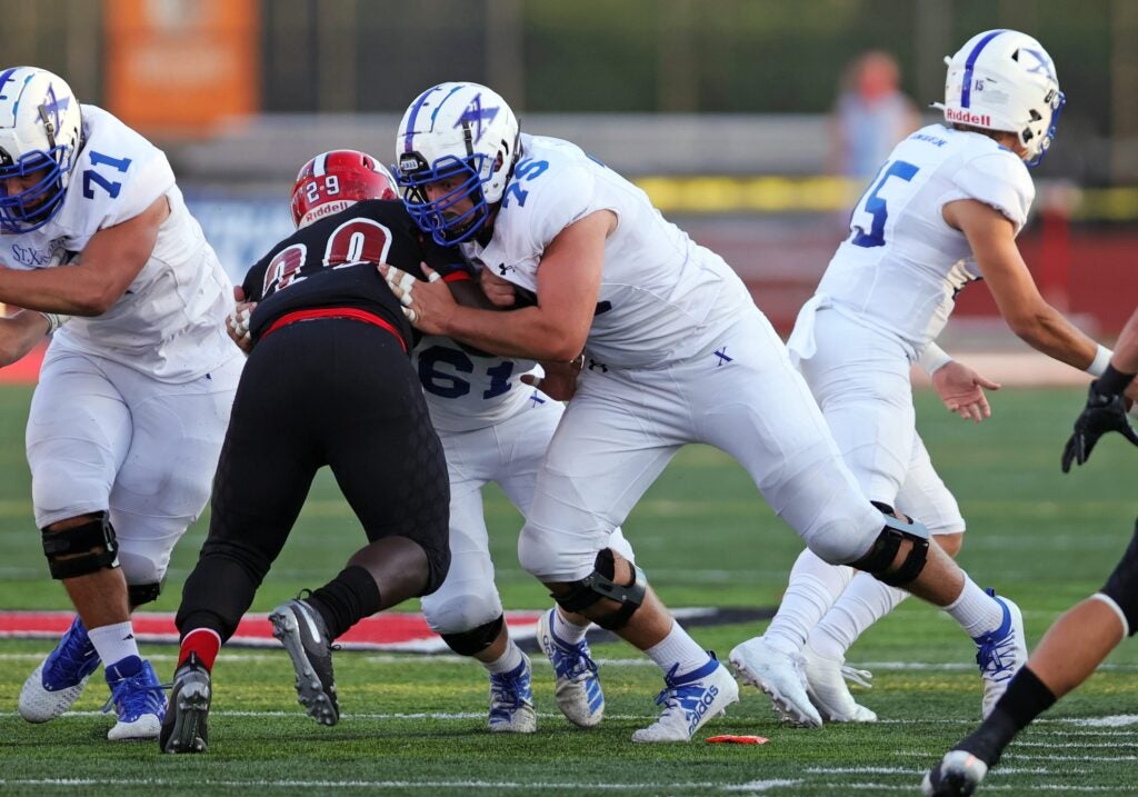 St. Xavier lineman Brian Parker [75] blocks a La Salle defender in the game between St. Xavier and La Salle high schools Sept. 4, 2020.