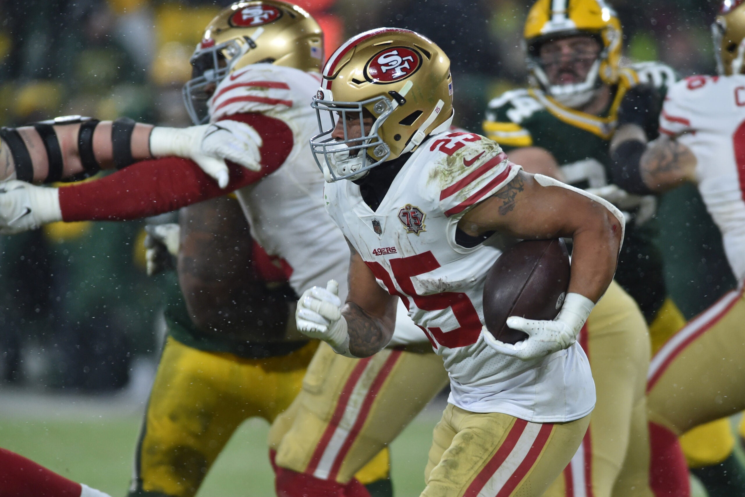 Jan 22, 2022; Green Bay, Wisconsin, USA; San Francisco 49ers running back Elijah Mitchell (25) in action against the Green Bay Packers during a NFC Divisional playoff football game at Lambeau Field.