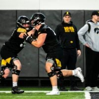 Iowa offensive lineman, left, Griffin Liddle runs a drill with Beau Stephens during a spring NCAA football practice, Thursday, March 30, 2023, at the University of Iowa Indoor Practice Facility in Iowa City, Iowa.