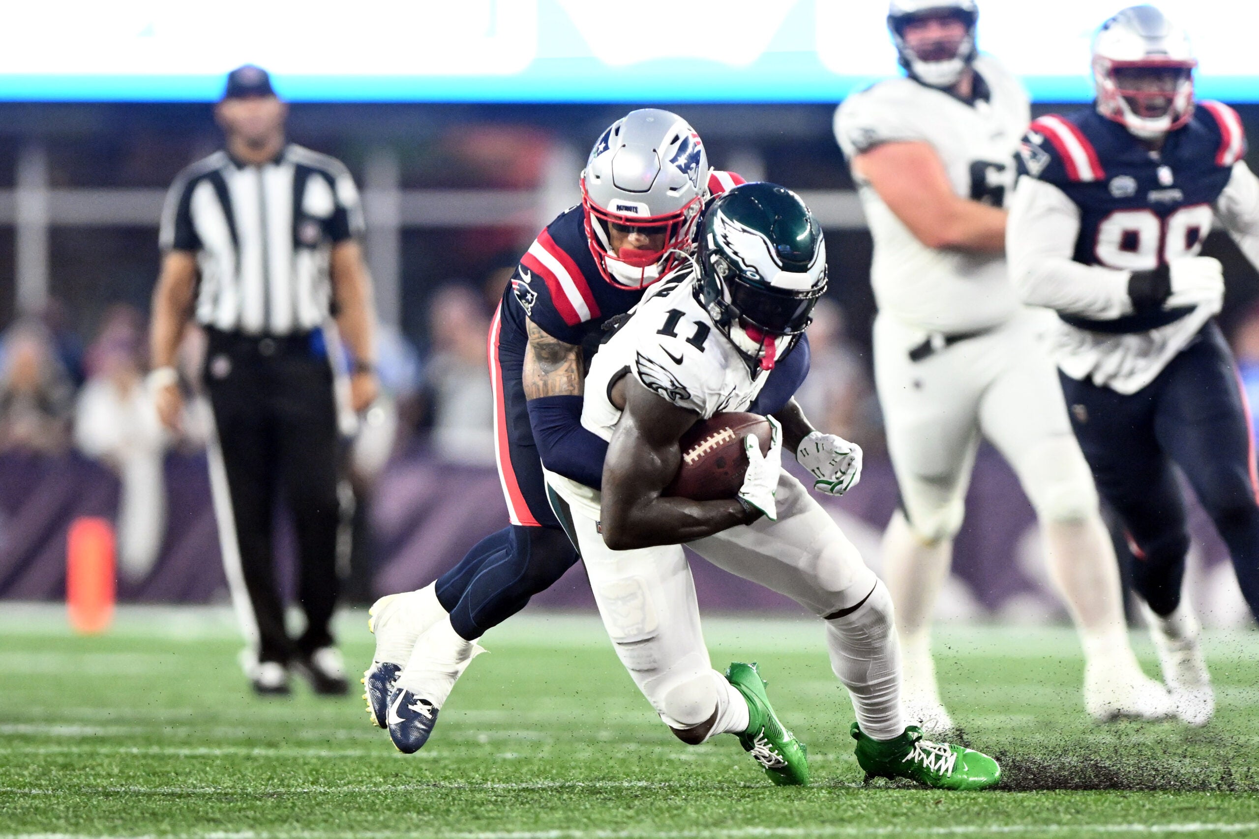 Sep 10, 2023; Foxborough, Massachusetts, USA; Philadelphia Eagles wide receiver A.J. Brown (11) is tackled by New England Patriots cornerback Christian Gonzalez (6) during the second half at Gillette Stadium.