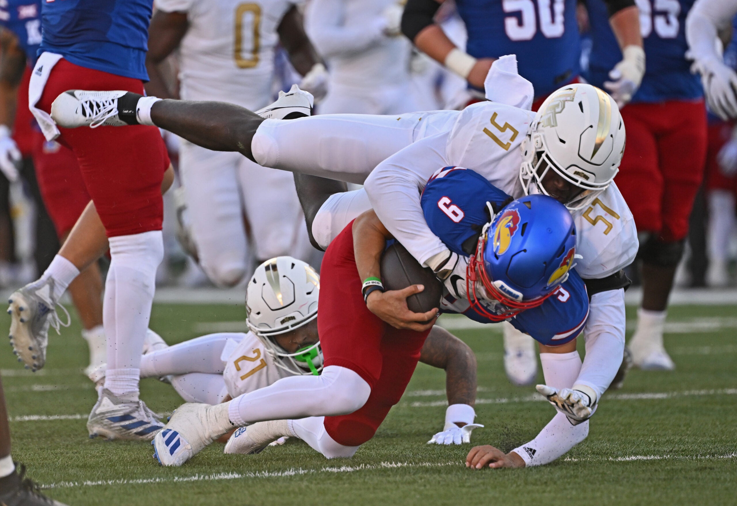 Oct 7, 2023; Lawrence, Kansas, USA; UCF Knights defensive end Malachi Lawrence (51) tackles Kansas Jayhawks quarterback Jason Bean (9) during the second half at David Booth Kansas Memorial Stadium.