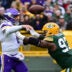 Oct 29, 2023; Green Bay, Wisconsin, USA; Minnesota Vikings quarterback Kirk Cousins (8) gets a pass away while under pressure from Green Bay Packers linebacker Kenny Clark (97) in the first quarter at Lambeau Field.