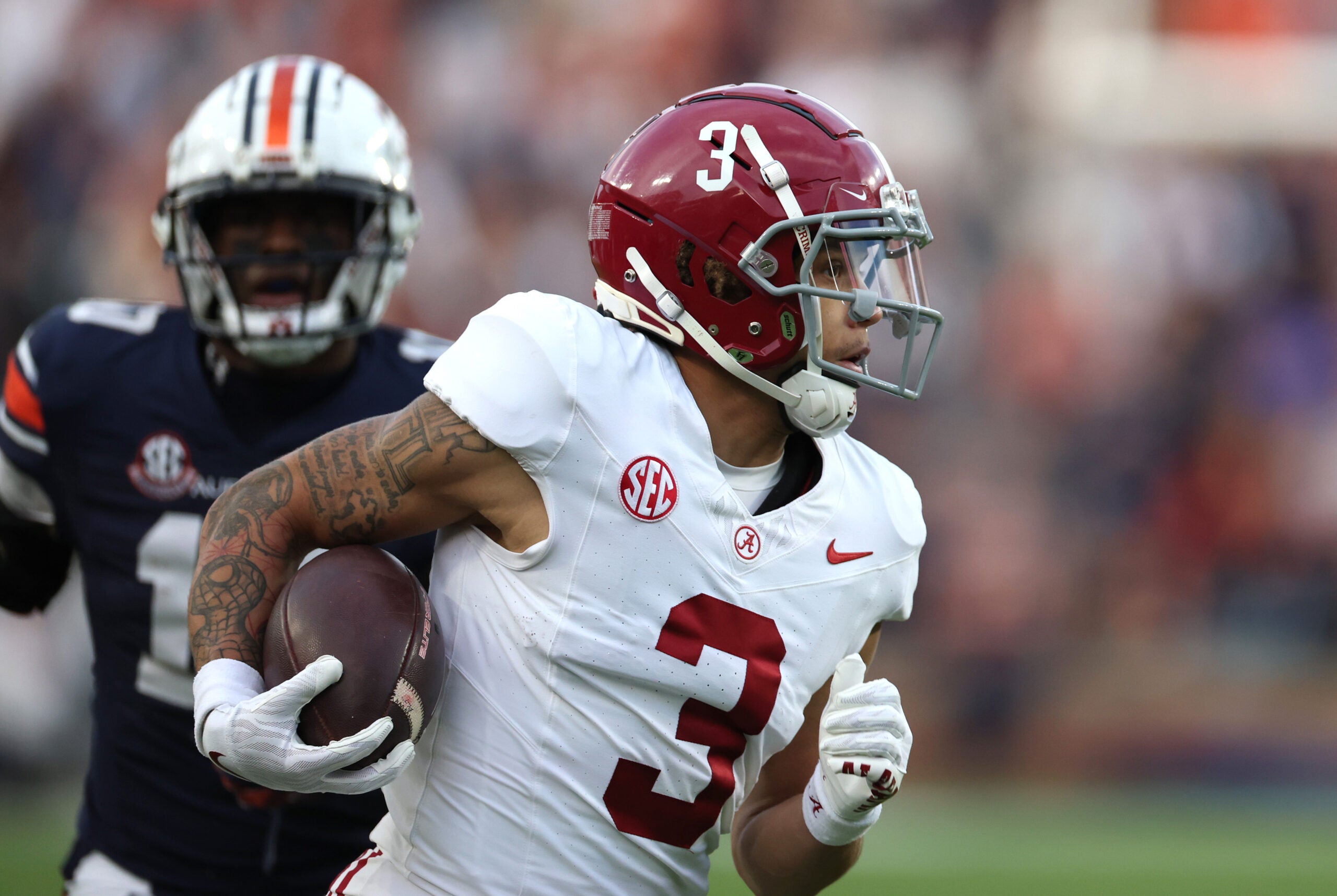 Nov 25, 2023; Auburn, Alabama, USA; Alabama Crimson Tide wide receiver Jermaine Burton (3) carries for a touchdown during the second quarter against the Auburn Tigers at Jordan-Hare Stadium.