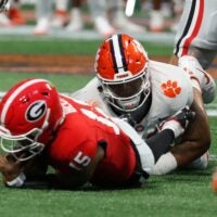 Clemson defensive lineman Peter Woods (11) sacks Georgia quarterback Carson Beck (15) during the first half of the NCAA Aflac Kickoff Game against Clemson in Atlanta, on Saturday, Aug. 31, 2024.