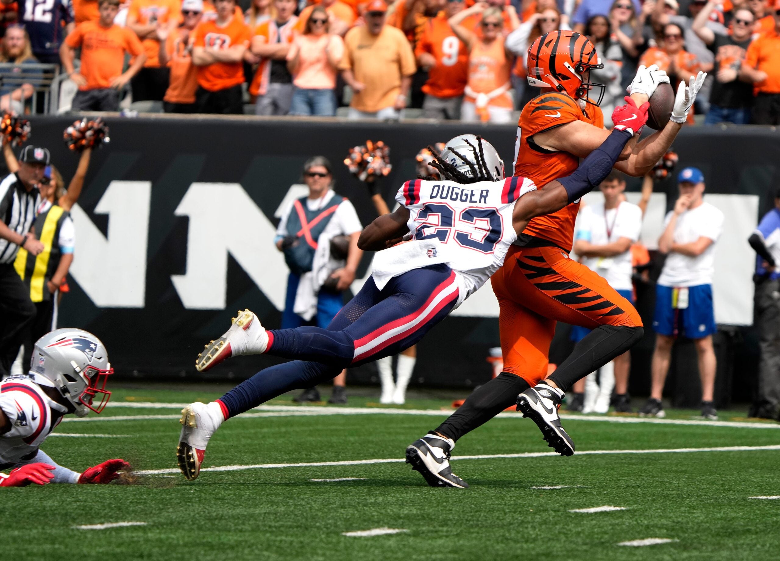 Cincinnati Bengals tight end Tanner Hudson (87) makes a catch as New England Patriots safety Kyle Dugger (23) puts on the pressure, Hudson dropped the ball and Patriots Marcus Jones recovered the ball in the 2nd quarter at Paycor Stadium Sunday, September 8, 2024.