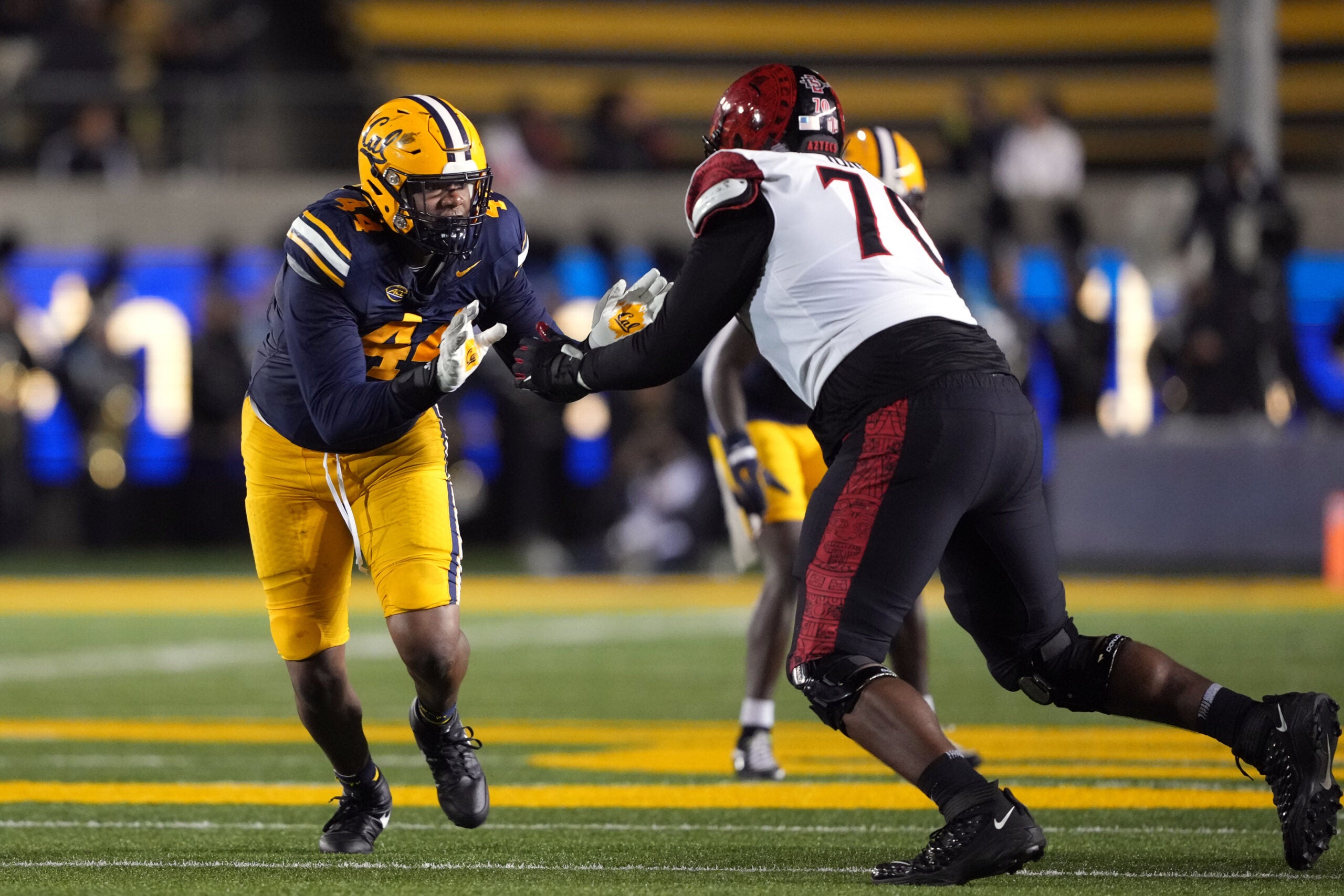 Sep 14, 2024; Berkeley, California, USA; California Golden Bears linebacker Xavier Carlton (left) rushes against San Diego State Aztecs offensive lineman Christian Jones (right) during the second quarter at California Memorial Stadium.