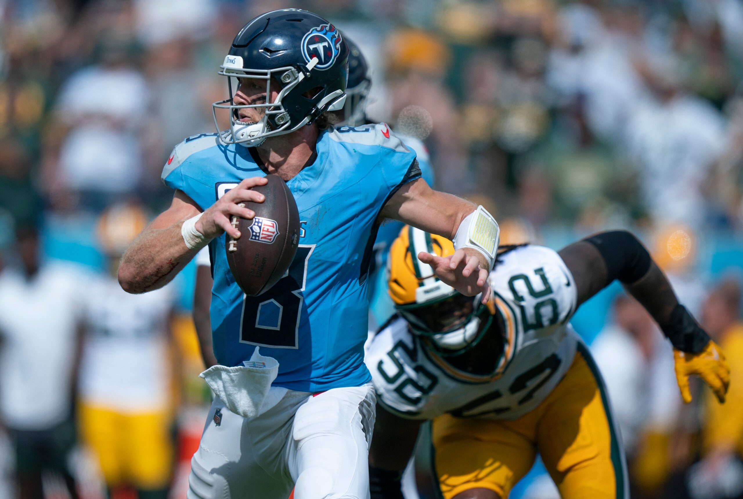 Tennessee Titans quarterback Will Levis (8) is pressured by Green Bay Packers defensive end Rashan Gary (52) during their game at Nissan Stadium in Nashville, Tenn., Sunday, Sept. 22, 2024.