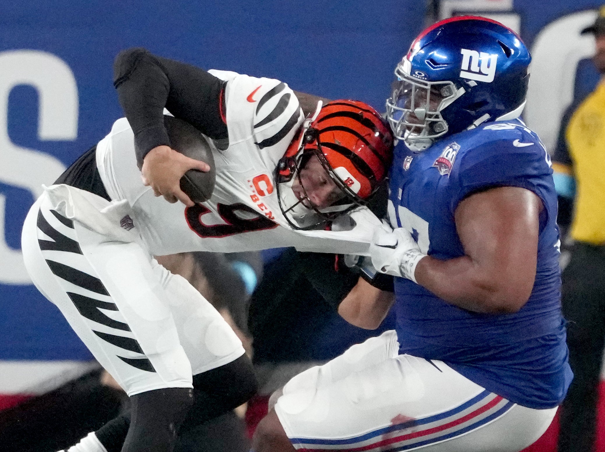 Oct 13, 2024; East Rutherford, New Jersey, USA; Cincinnati Bengals quarterback Joe Burrow (9) is sacked by New York Giants defensive tackle Dexter Lawrence II (97) in the 3rd quarter at MetLife Stadium.