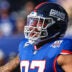 Nov 3, 2024; East Rutherford, New Jersey, USA; New York Giants defensive tackle Dexter Lawrence (97) reacts during introductions before the game against the Washington Commanders at MetLife Stadium.