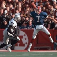In true Flutie form, Doug Flutie leaps high to get a pass over Raiders LB Lance Johnstone. The Bills beat the Raiders 44-21.