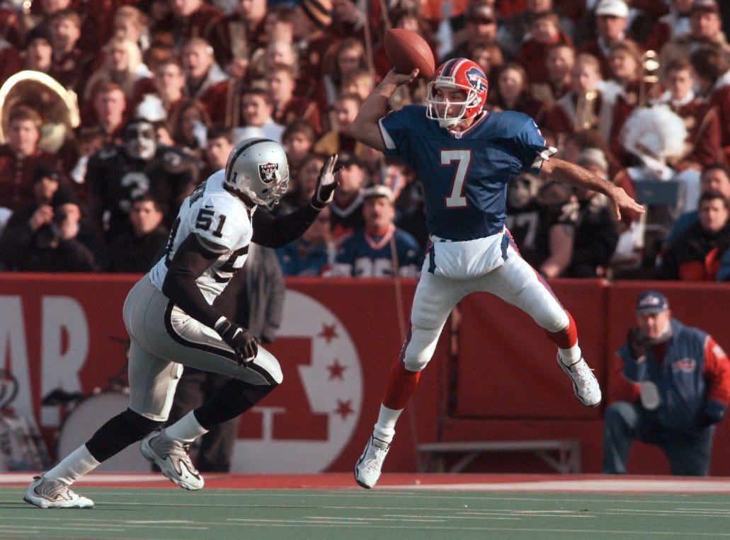 In true Flutie form, Doug Flutie leaps high to get a pass over Raiders LB Lance Johnstone. The Bills beat the Raiders 44-21.