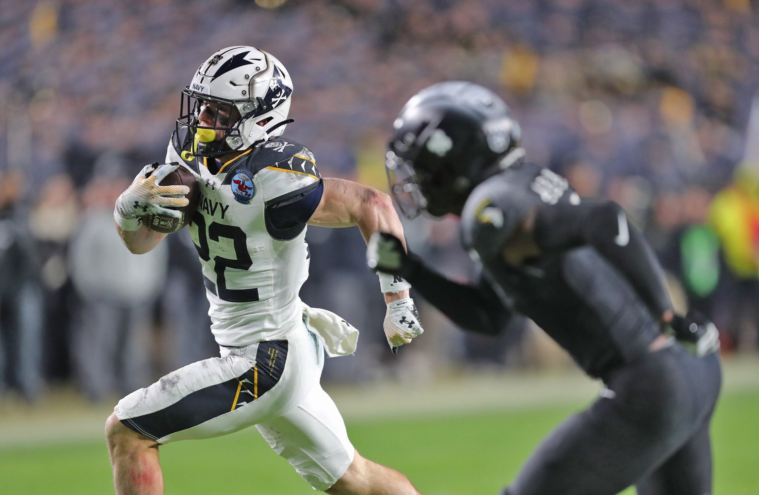Dec 14, 2024; Landover, Maryland, USA; Navy Midshipmen running back Eli Heidenreich (22) runs with the ball against the Army Black Knights during the second half of the the 125th Army-Navy game at Northwest Stadium.