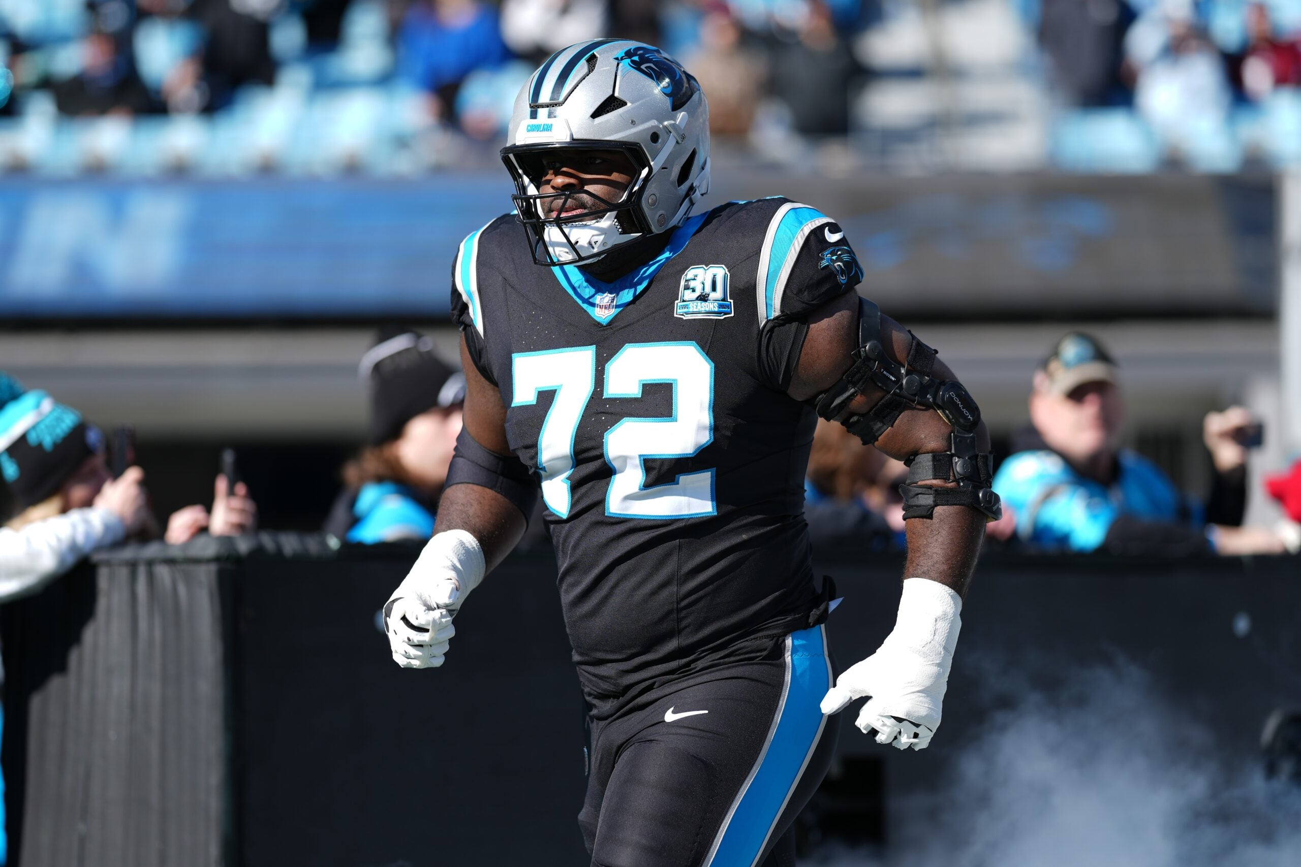Dec 22, 2024; Charlotte, North Carolina, USA; Carolina Panthers offensive tackle Taylor Moton (72) takes the field during the first quarter against the Arizona Cardinals at Bank of America Stadium.