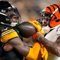 Pittsburgh Steelers cornerback Cory Trice Jr. (27) and Cincinnati Bengals wide receiver Ja'Marr Chase (1) tussle over a dead ball after a play in the second quarter of the NFL Week 18 game between the Pittsburgh Steelers and the Cincinnati Bengals at Acrisure Stadium in Pittsburgh on Saturday, Jan. 4, 2025.