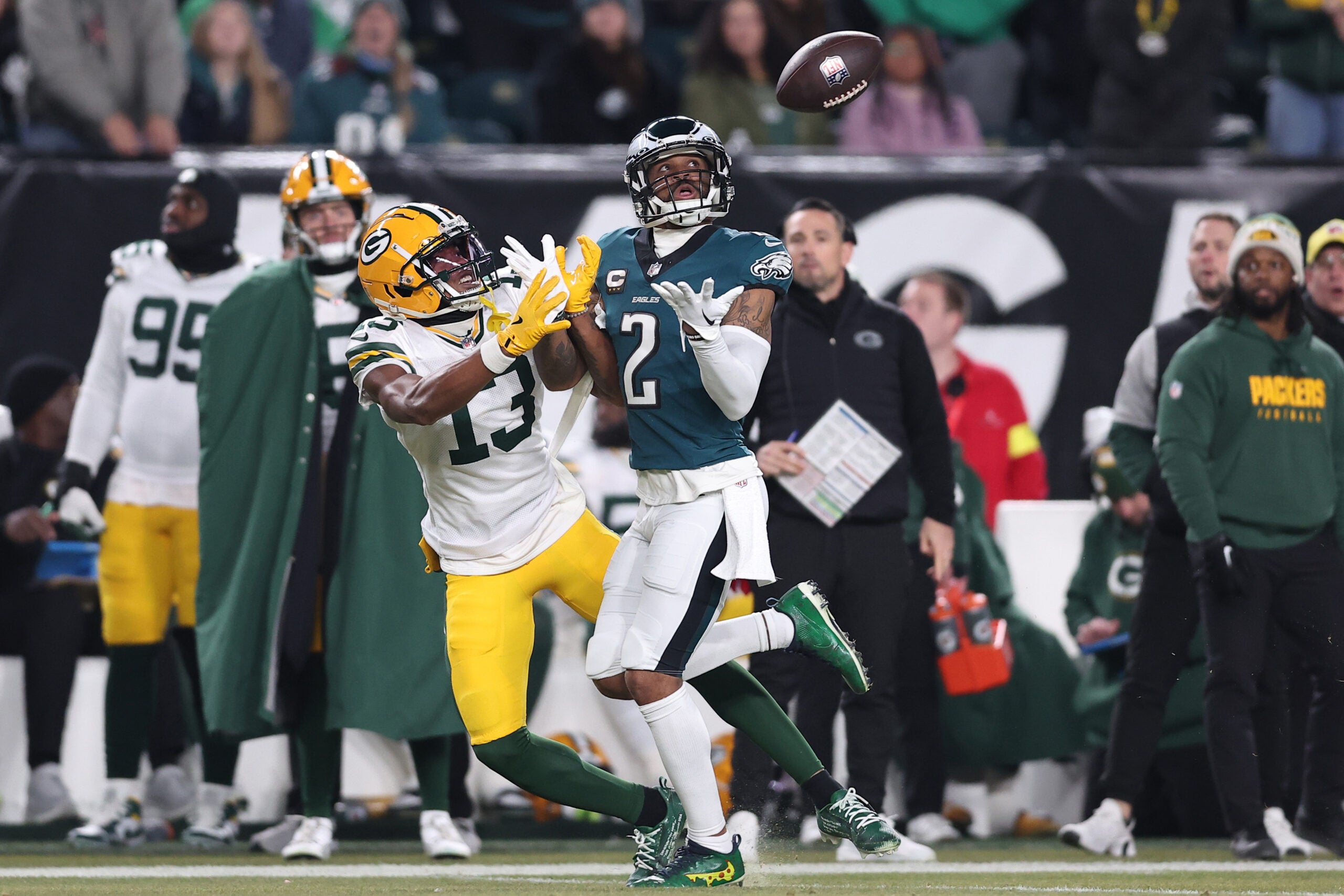Jan 12, 2025; Philadelphia, Pennsylvania, USA; Philadelphia Eagles cornerback Darius Slay Jr. (2) makes an interception against Green Bay Packers wide receiver Dontayvion Wicks (13) during the first half in an NFC wild card game at Lincoln Financial Field.