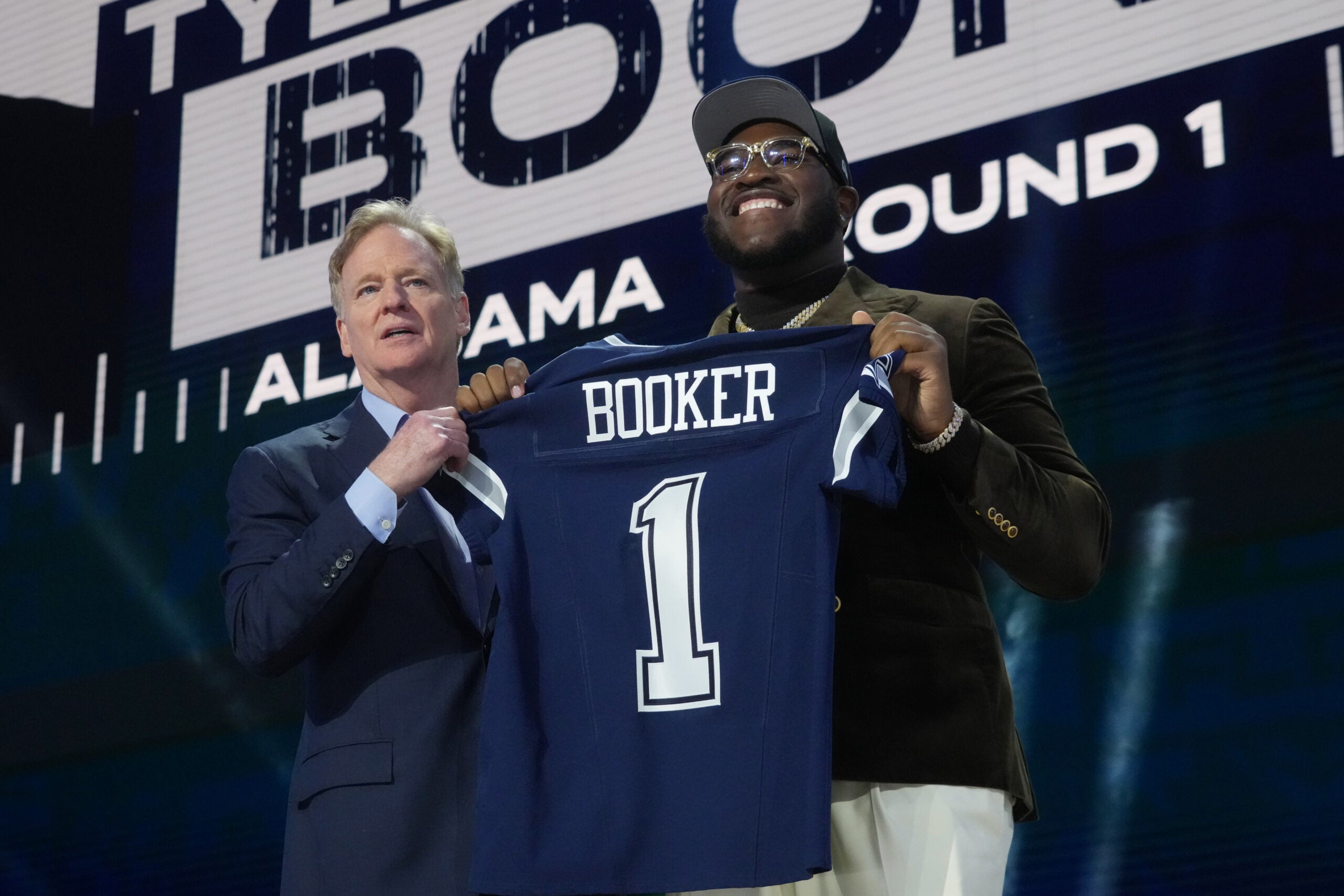 Apr 24, 2025; Green Bay, WI, USA; NFL commissioner Roger Goodell with Alabama Crimson Tide offensive lineman Tyler Booker after he is selected by the Dallas Cowboys as the number twelve pick in the first round of the 2025 NFL Draft at Lambeau Field.