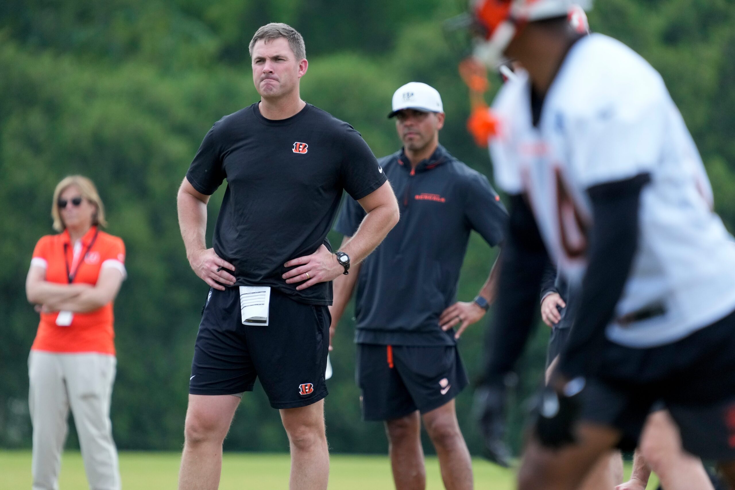 Cincinnati Bengals head coach Zac Taylor watches during a session of organized team activities on the Bengals practice field at Paycor Stadium in downtown Cincinnati on Tuesday, June 3, 2025.