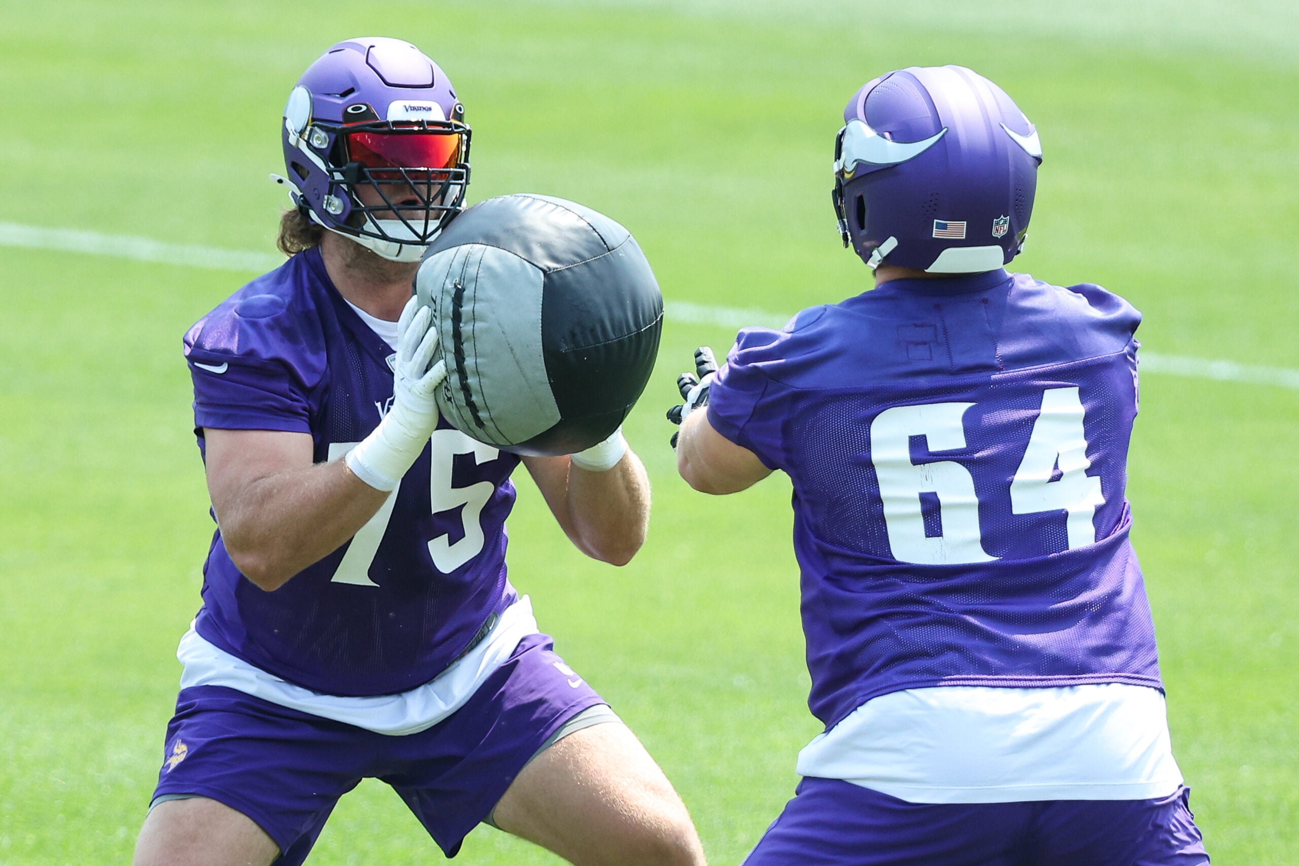 Jun 10, 2025; Minneapolis, MN, USA; Minnesota Vikings offensive tackle Brian O'Neill (75) and guard Blake Brandel (64) practice during minicamp at the Minnesota Vikings Training Facility.