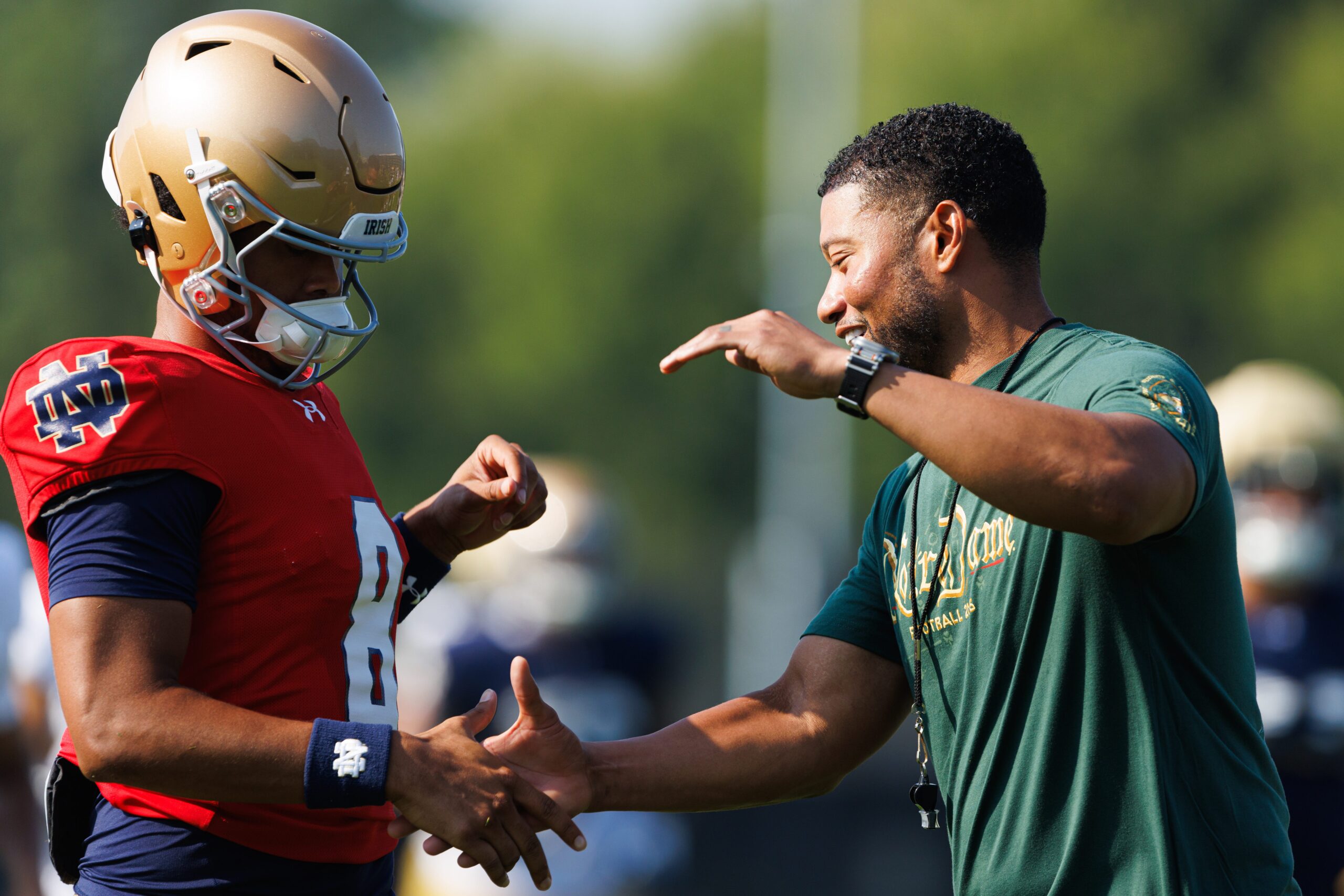 Notre Dame head coach Marcus Freeman, right, greets quarterback Kenny Minchey (8) during a football practice at Irish Athletic Center on Wednesday, Aug. 6, 2025, in South Bend.