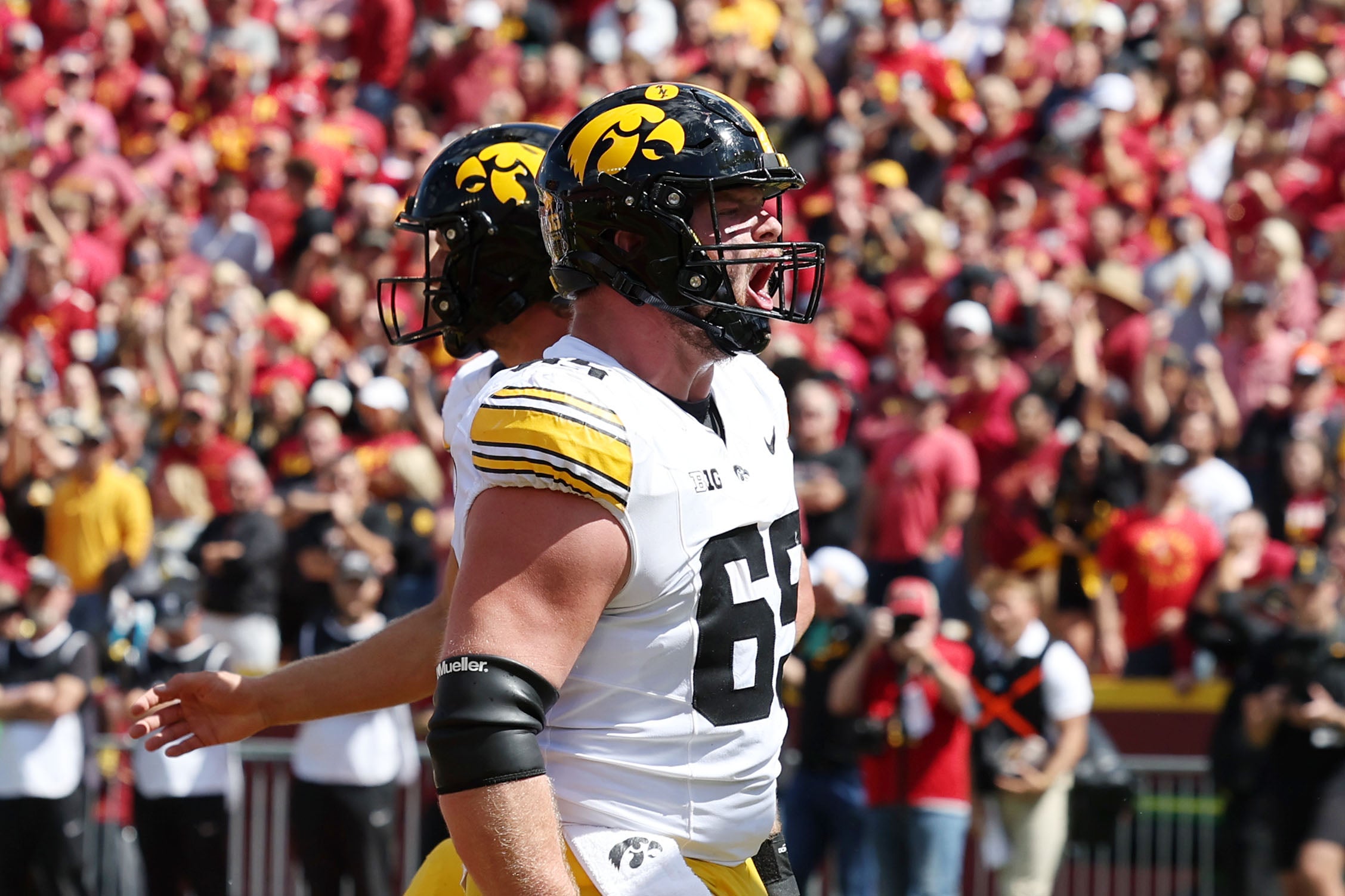 Sep 6, 2025; Ames, Iowa, USA; Iowa Hawkeyes offensive lineman Logan Jones (65) reacts after a play against the Iowa State Cyclones during the second half at Jack Trice Stadium.