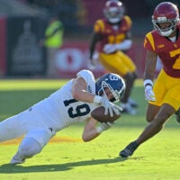 Sep 6, 2025; Los Angeles, California, USA; Georgia Southern Eagles wide receiver Josh Dallas (19) hangs on to the ball in front of USC Trojans safety Kamari Ramsey (7) for a first down during the first half at the Los Angeles Memorial Coliseum.