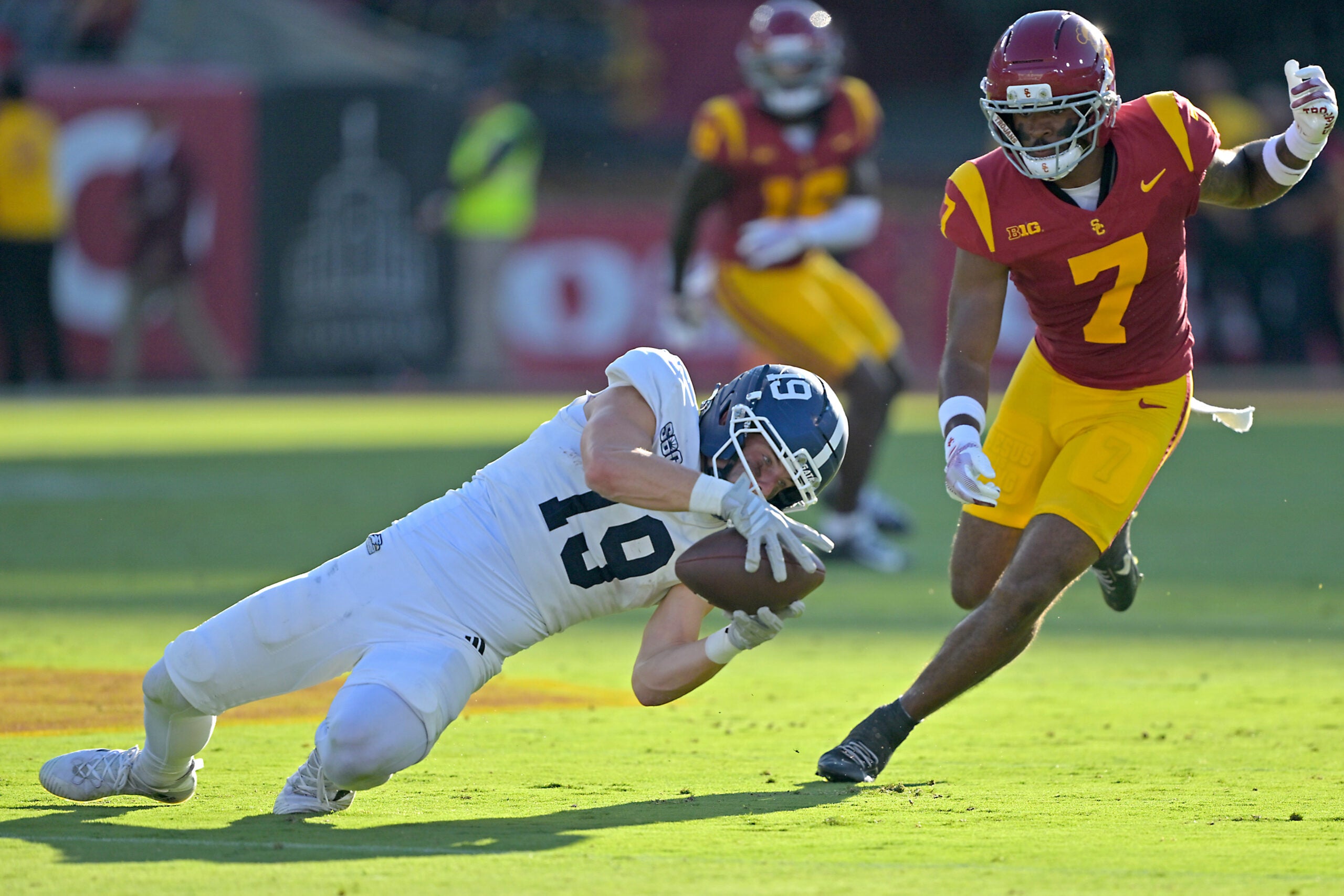 Sep 6, 2025; Los Angeles, California, USA; Georgia Southern Eagles wide receiver Josh Dallas (19) hangs on to the ball in front of USC Trojans safety Kamari Ramsey (7) for a first down during the first half at the Los Angeles Memorial Coliseum.