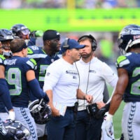 Seahawks head coach Mike MacDonald addresses team on the sideline