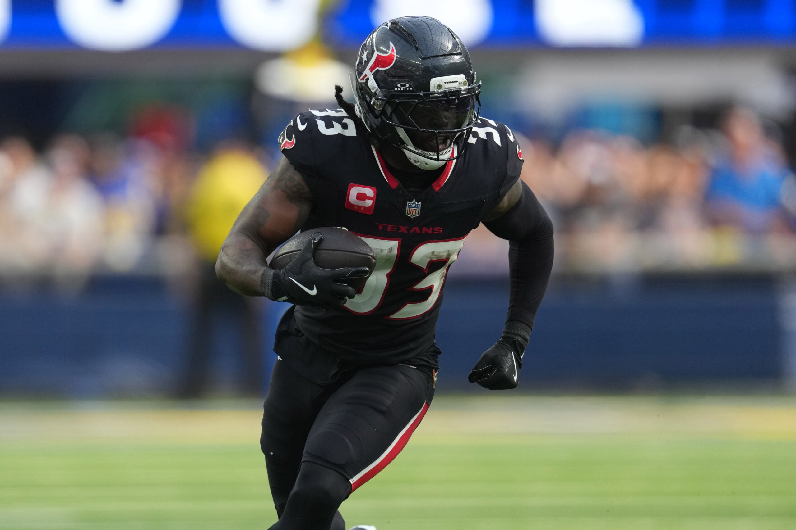 Sep 7, 2025; Inglewood, California, USA; Houston Texans running back Dare Ogunbowale (33) carries the ball against the Los Angeles Rams in the second half at SoFi Stadium.