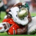 Sep 13, 2025; Miami Gardens, Florida, USA; Miami Hurricanes defensive lineman Rueben Bain Jr. (4) tackles South Florida Bulls wide receiver Christian Neptune (81) in the third quarter at Hard Rock Stadium.