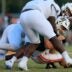 Mandarin's Knox Annis (8), center, is tackled by IMG Academy's Censere Gayloard (21), center back, along with Zyron Forstall (0), left, and Joseph Graves (75), top, during the second quarter of a high school football matchup at Mandarin High School, Friday, Sept. 19, 2025, in Jacksonville, Fla. The IMG Academy Ascenders defeated the Mandarin Mustangs 57-7.