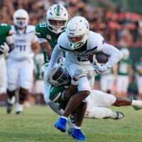 IMG Academy's Osani Gayles (13) rushes for yards against Mandarin's Tamajh Mitchell (7) during the first quarter of a high school football matchup at Mandarin High School, Friday, Sept. 19, 2025, in Jacksonville, Fla. The IMG Academy Ascenders defeated the Mandarin Mustangs 57-7.