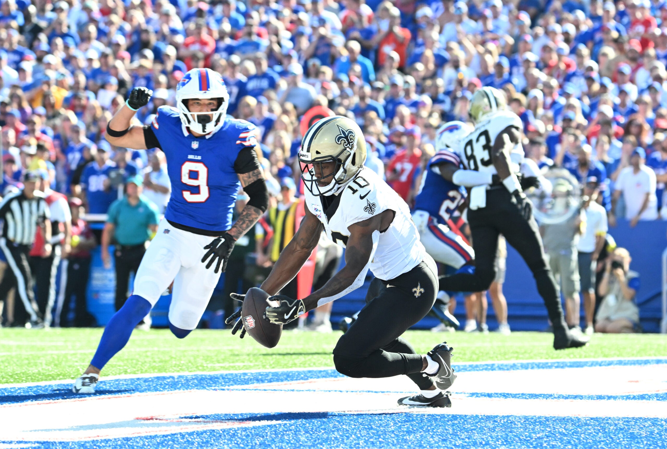 Sep 28, 2025; Orchard Park, New York, USA; New Orleans Saints wide receiver Brandin Cooks (10) drops a pass in the end zone under pressure from Buffalo Bills safety Taylor Rapp (9) during the fourth quarter at Highmark Stadium.